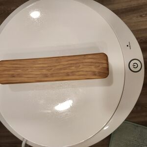 Modern White and Brown Circular Appliance with Wooden Grip